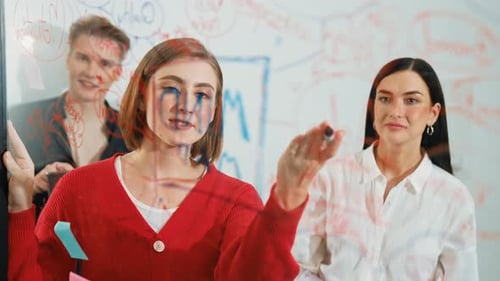 Creative Team Brainstorming Ideas on Whiteboard in Office