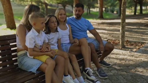 Family Enjoying Quality Time Together on Park Bench