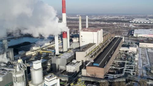 White steam pushed into the air from a chimney of a Coal-Fired thermal power plant.