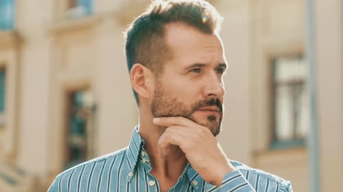 Man with Beard Contemplating Thoughts Outdoors
