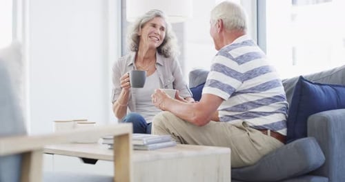 Senior Couple Relaxing at Home with Coffee