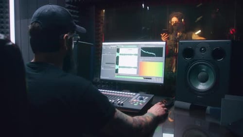 Musician in Sound Recording Studio with Sound Engineer