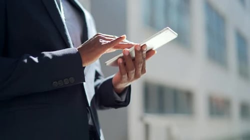 close up of afro american businessman hands using tablet. A black business man in a formal suit