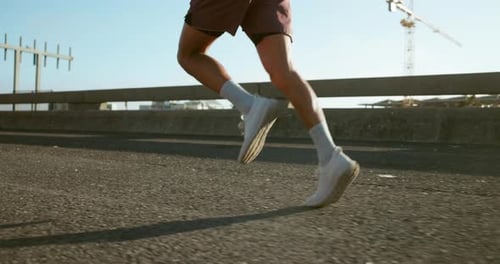 Running, fitness and feet of person in city for workout, marathon training and exercise