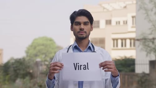 Doctor Holding Sign with 'Viral' Message