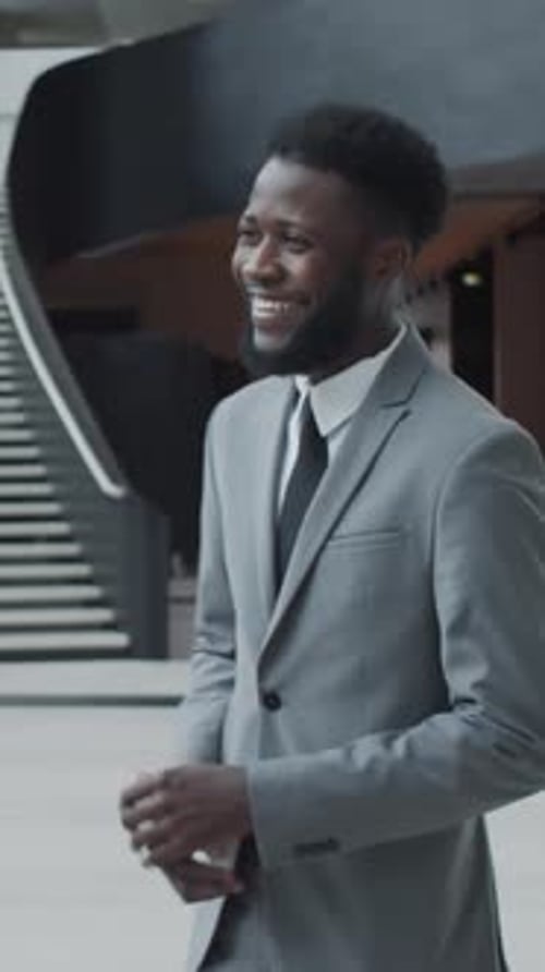 Black Businessman Talking with Colleague in Modern Office Building