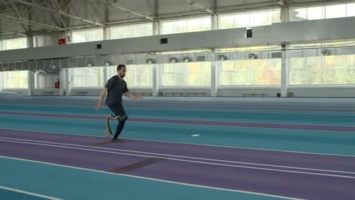 Athlete Practicing Long Jump at Indoor Stadium