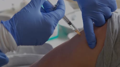 Close-up of a person receiving the COVID vaccine.