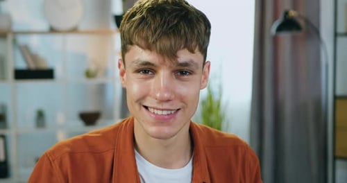 Close up portrait of man looking into camera with confident face expression indoors