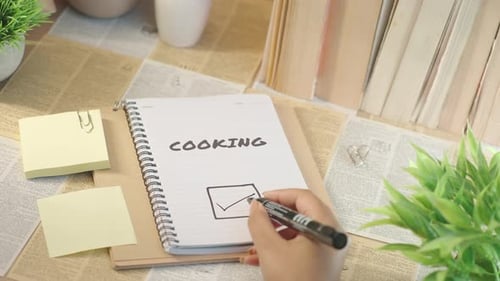 Hand draws Checkmark on Cooking To Do List