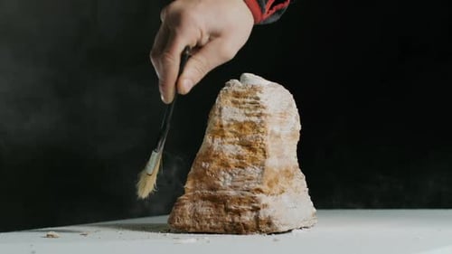 Closeup Sculptor Works with a Special Tool for Carving Stone Figures