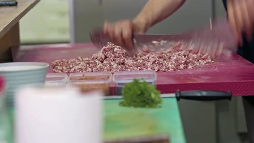 Mincing Raw Meat With Cleaver in Kitchen
