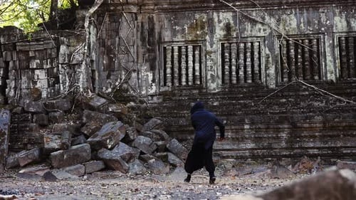 Cloaked Oni Turns In Place With Sword