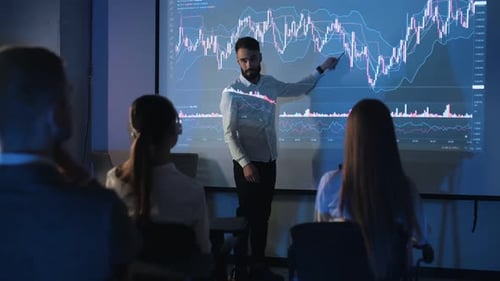 Man Showing Financial Chart to Audience at Presentation
