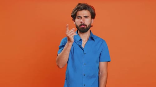 Man Gesturing No Against Orange Background