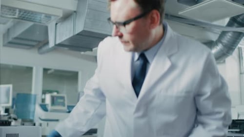 Scientist Working With Computer in Modern Laboratory