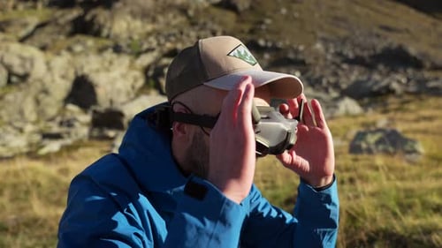 Drone pilot prepares for flight by wearing FPV drone goggles