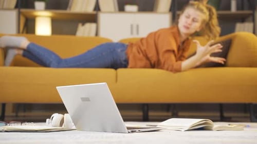 Woman Video Conferencing Lying on Couch Indoors