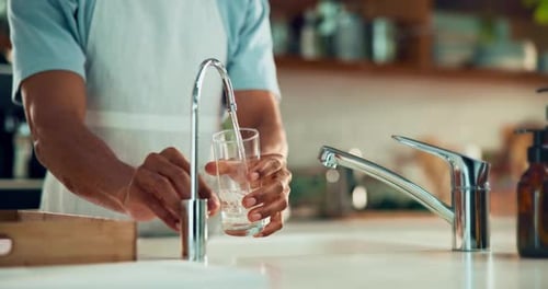 Glass Filling with Water at Kitchen Faucet