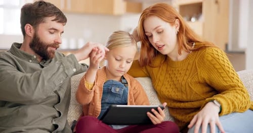 Family Using Tablet Together on Sofa at Home