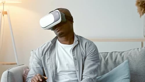 Man Immersed in Virtual Reality Experience at Home