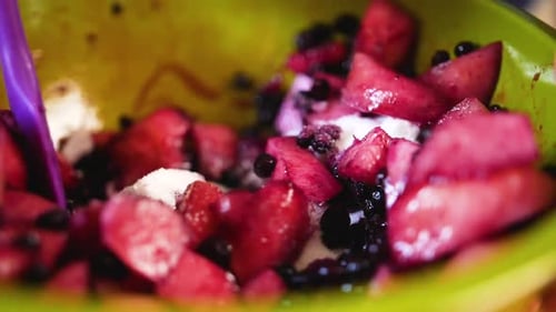 close up mixing sugar with fruit for a pie filling
