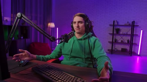 Young Man Talking in Front of Computer