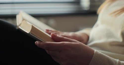 Young Woman Reading Book in Cozy Living Room Turning Page Learning Studying Education Read Books