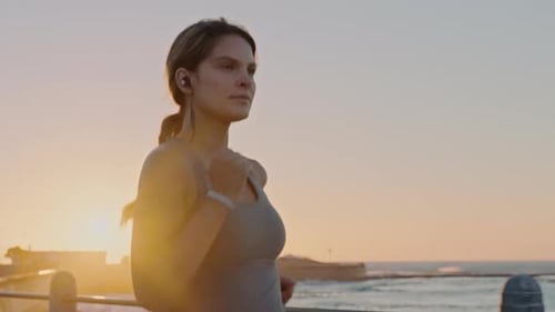 Beach, earphones and woman running at sunset for health, wellness and exercise