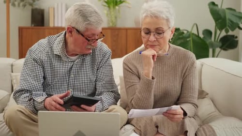 Senior Couple Works on Finances at Home