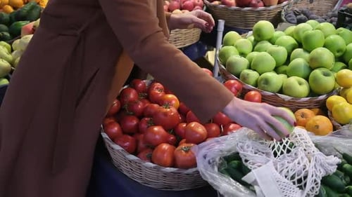 Young Woman Choosing Green Apples at Fruit Vegetable Shelf in Grocery Store Healthy Food Nutrition