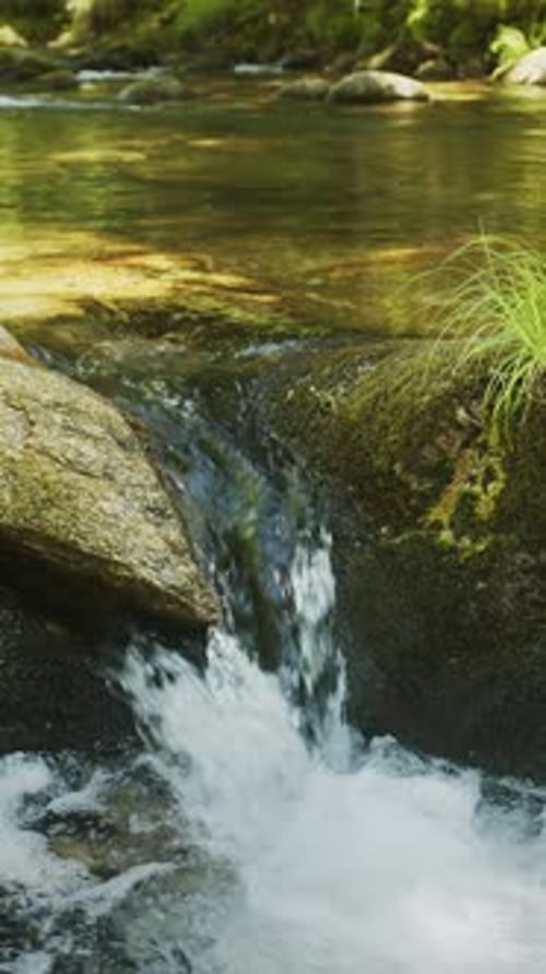 Pure, sparkling, bubbling and cascading water of nearby stream close up.