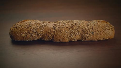 Fresh Baked Seeded Bread Loaf on Wooden Table