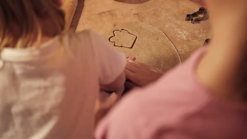 Children Rolling Out Cookie Dough with Wooden Rolling Pin on the Kitchen Countertop Kids Baking