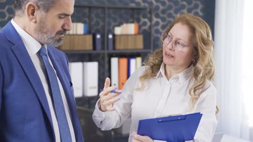 Business Professionals Discussing a Document in Office