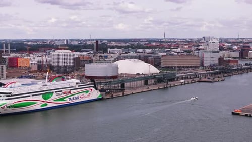 Aerial Footage of Harbour and Large Ship Modern Buildings in Urban Borough in Background Helsinki