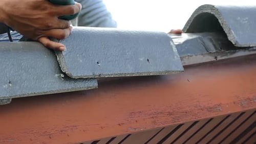 Asian Man work on Roof installation, Close Up