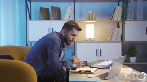 Man working on laptop in home office