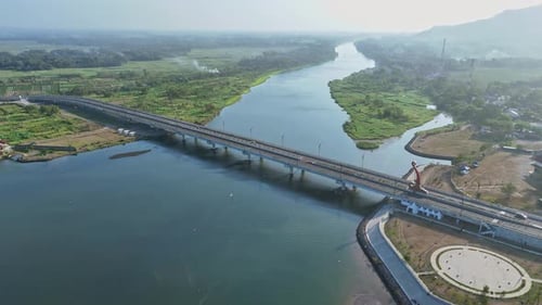 Aerial view of bridge on the big river. Indonesia. 4K drone shot.