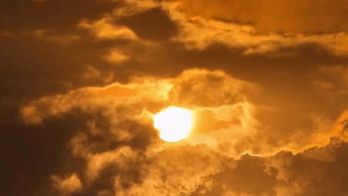 Sun Shining Brightly Through Shifting Golden Clouds
