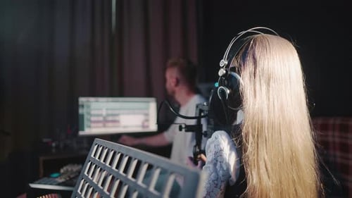 Girl Sings with Teacher in Audio Studio