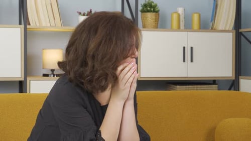 Woman Sitting on Couch Crying