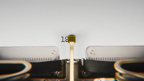 Old mechanical typewriter typing Year 1985 in a close-up view.