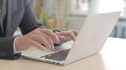 Close Up of Businessman Typing on Laptop