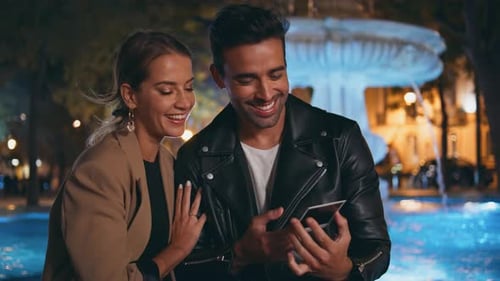 Happy Spouses Holding Photo in Night Park Closeup Joyful Couple Kissing on Date