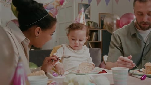 Family Celebrates Baby's First Birthday with Cake