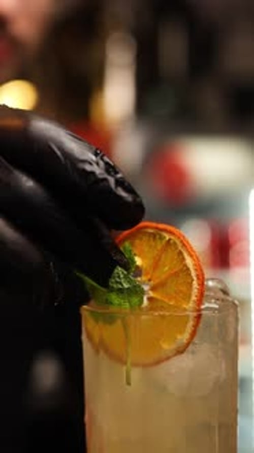 the bartender at the bar prepares alcoholic cocktails