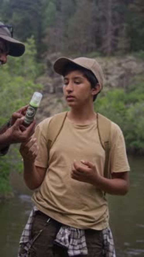 Applying Bug Spray for Outdoor Adventure