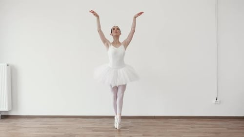 Ballerina Practices Elegant Ballet Poses in Studio