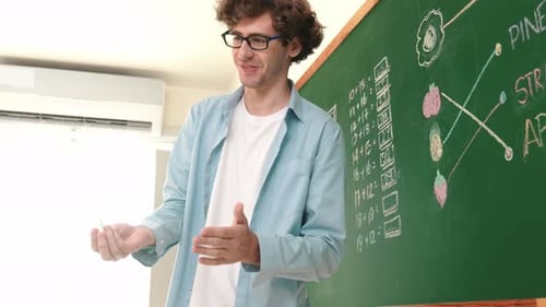 Man standing in front of chalkboard with calculations